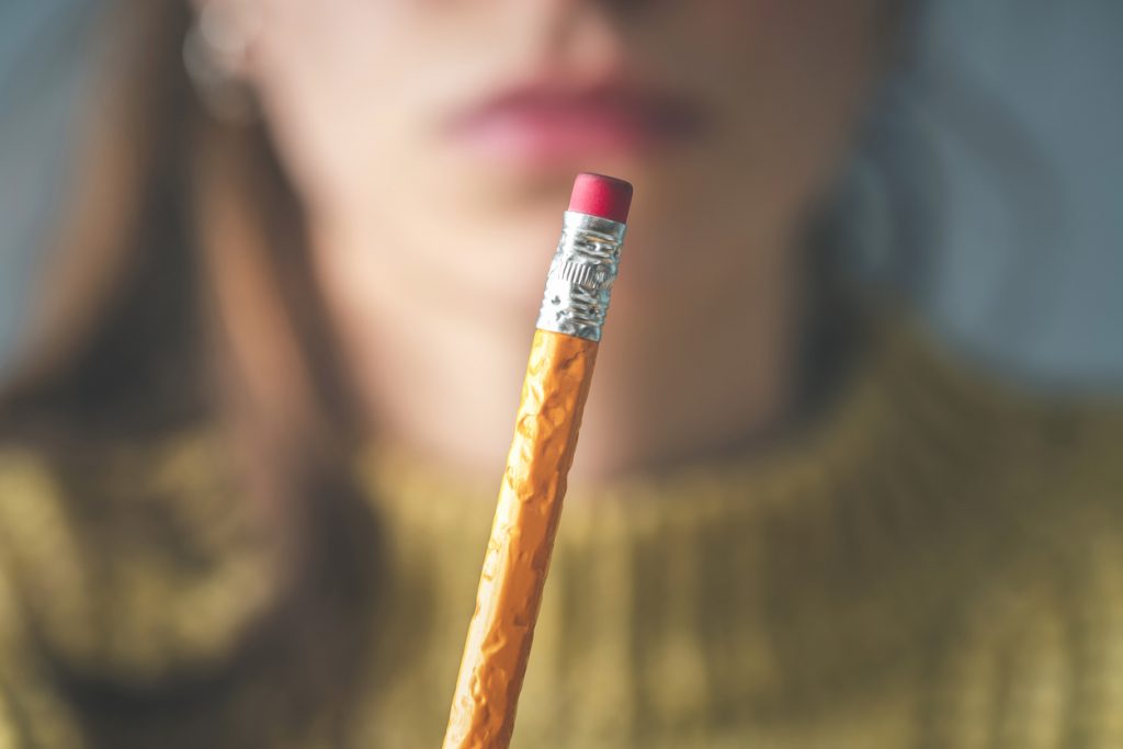 female showing chewed pencil