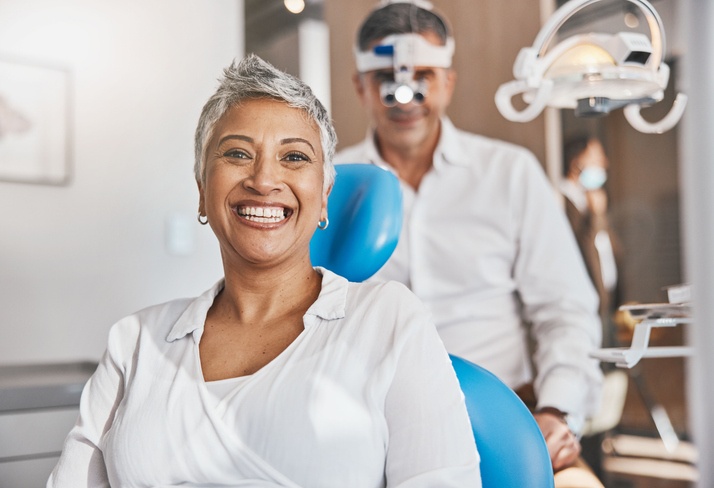 Smiling female patient after a dental implant procedure